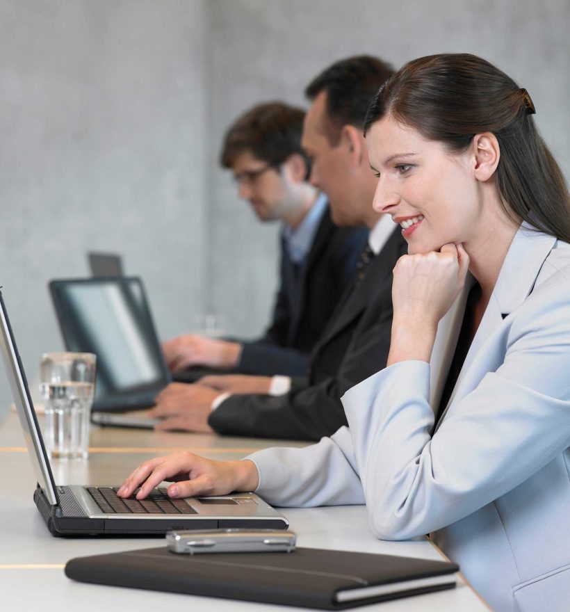 businesswoman-using-laptop-smiling-2022-03-08-00-21-51-utc.jpg